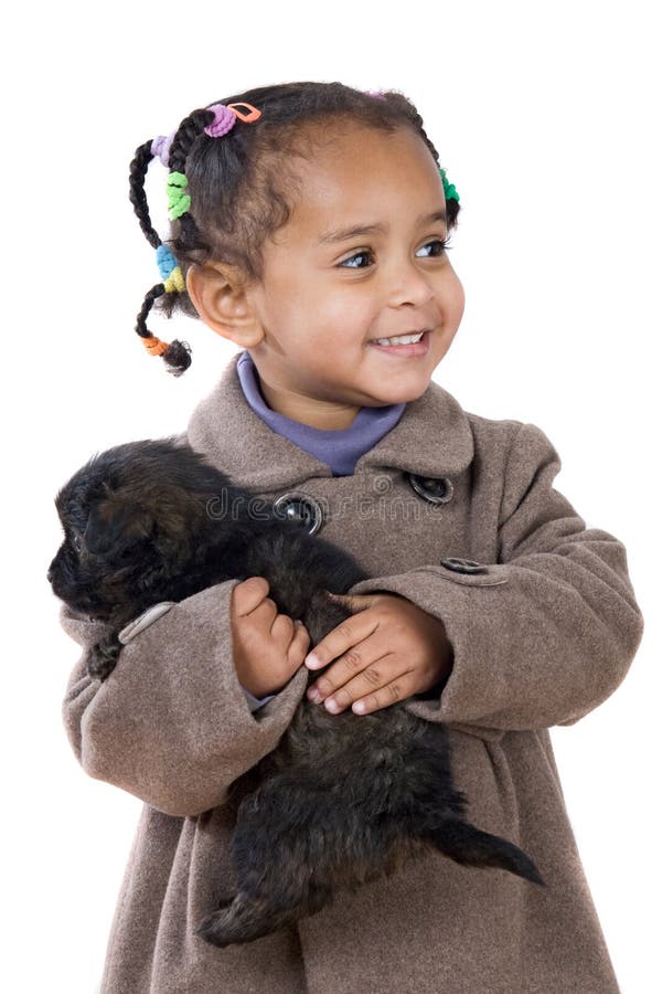 African baby holding a puppy on her arms