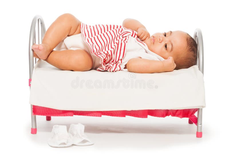 African baby in striped dress on the small bed royalty free stock photo African baby in striped dress on the small bed royalty free stock photo