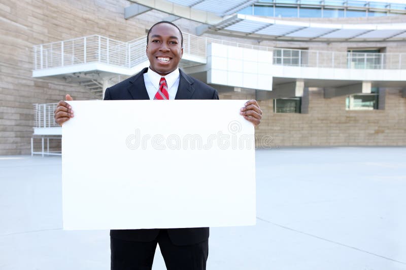 African Business Man Holding Sign royalty free stock photography