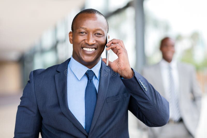 African businessman talking cell phone stock image