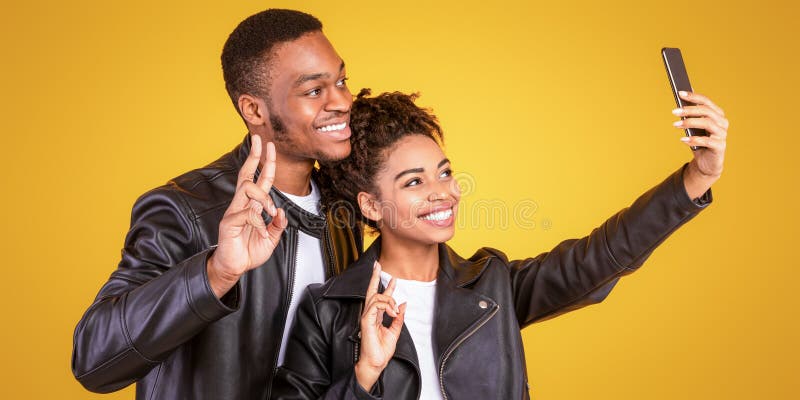 African Couple Making Selfie Gesturing Victory Sign Panorama Studio Shot arkivfoton