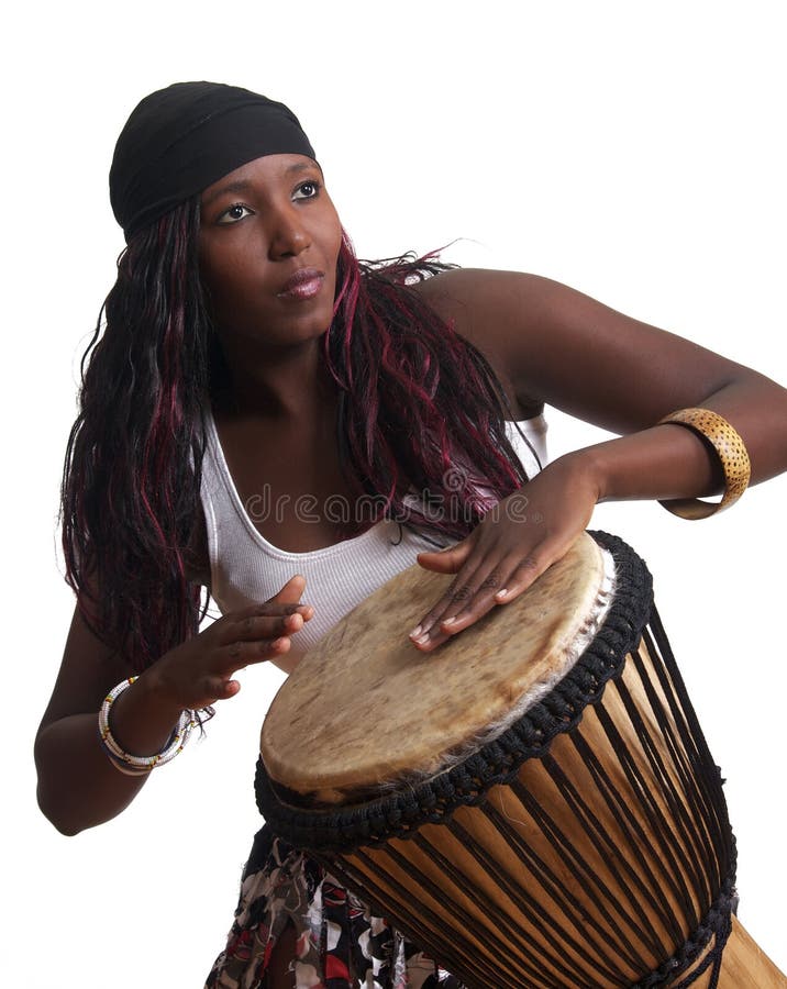 An African American plays the djembe drum, set against a white background. An African American plays the djembe drum, set against a white background.
