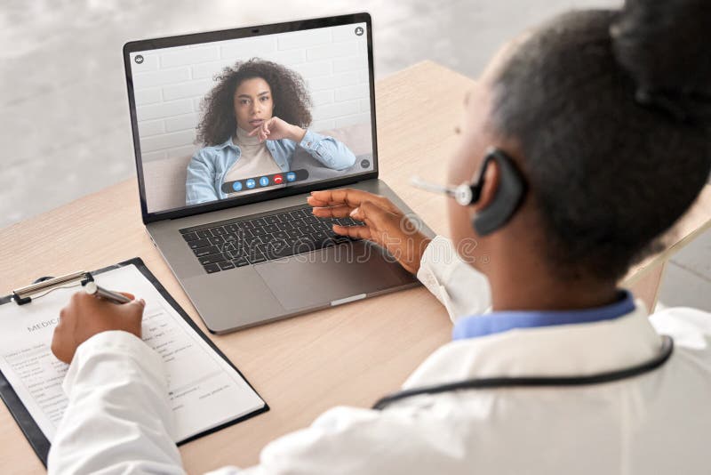 African doctor talk to patient by online webcam video call on laptop screen.