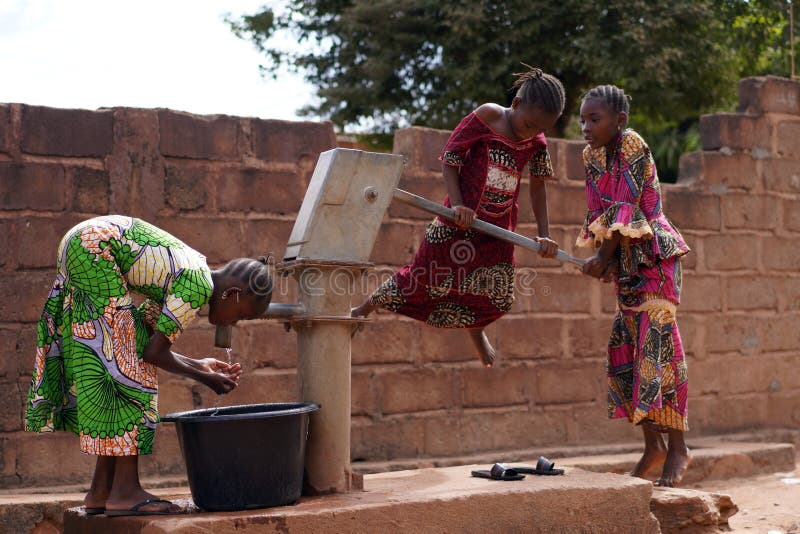 African Children Playing At The Village Water Pump Stock Photo