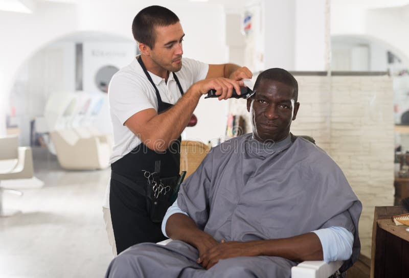 A Barber is Going through the Electric Cutting and Shaving Machine for the  Beard of an African-American Brazilian Boy Stock Image - Image of beauty,  business: 214303807