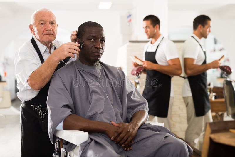 A Barber is Going through the Electric Cutting and Shaving Machine for the  Beard of an African-American Brazilian Boy Stock Image - Image of beauty,  business: 214303807