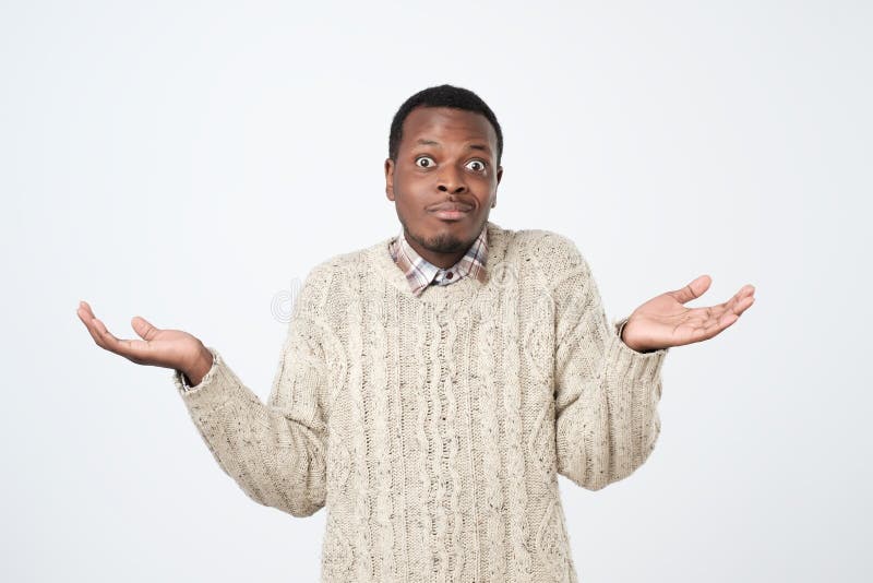 African Man in Sweater Shrugs Shoulders with Confusion Stock Photo ...