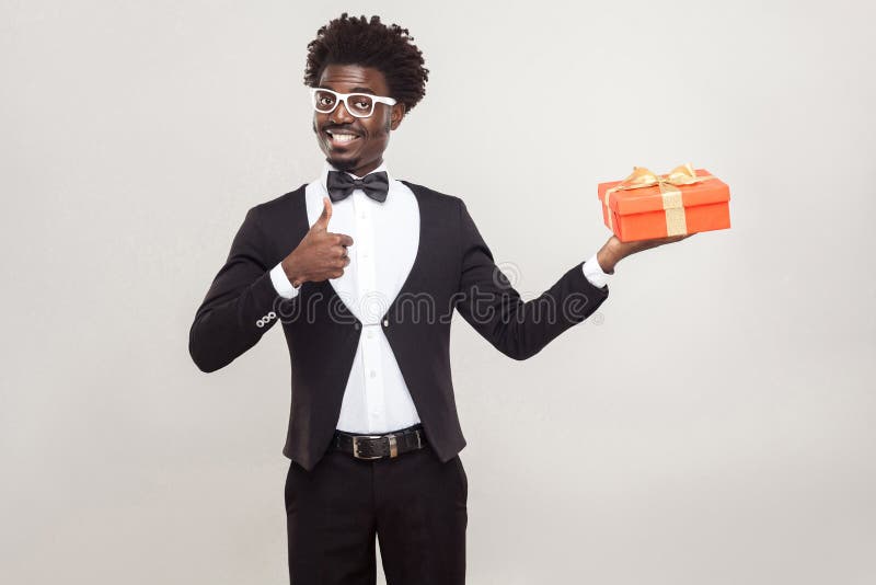 African Man Thumbs Up and Holding Gift Box. Stock Photo - Image of ...