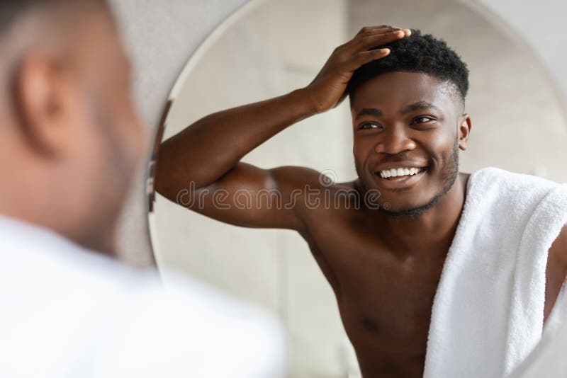 African Man Touching Short Curly Hair Near Mirror in Bathroom Stock Photo -  Image of home, cosmetology: 235429454