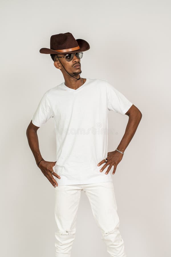 An african man with v-neck shirt doing a pose while facing sideways with white background