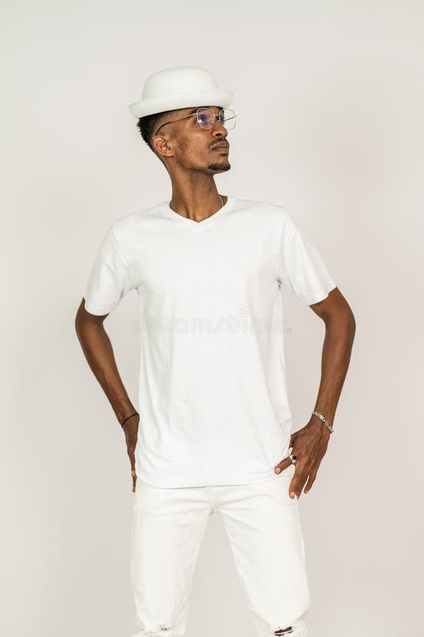 An african man with v-neck shirt doing a pose while facing sideways with white background