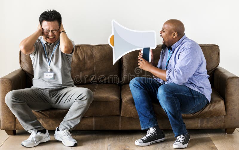 African man using speaker icon and disturbing another man stock image African man using speaker icon and disturbing another man stock image
