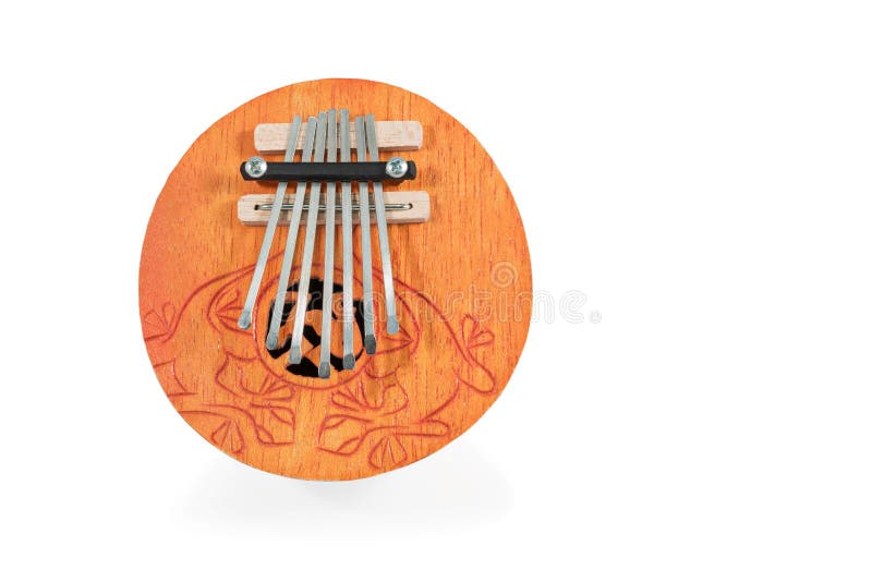 African round played by plucking musical instrument Kalimba, with carved ornaments, isolated on white background. African round played by plucking musical instrument Kalimba, with carved ornaments, isolated on white background