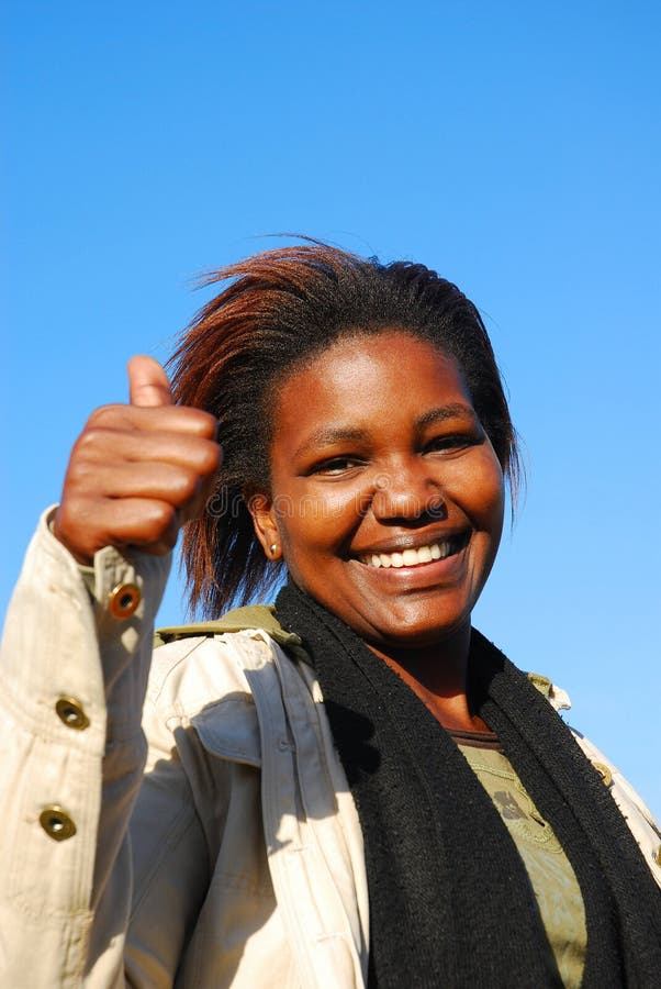 Externo retrato hermoso joven negro optimista una mujer feliz expresión posesión arriba su pulgar buscando k positivo futuro.