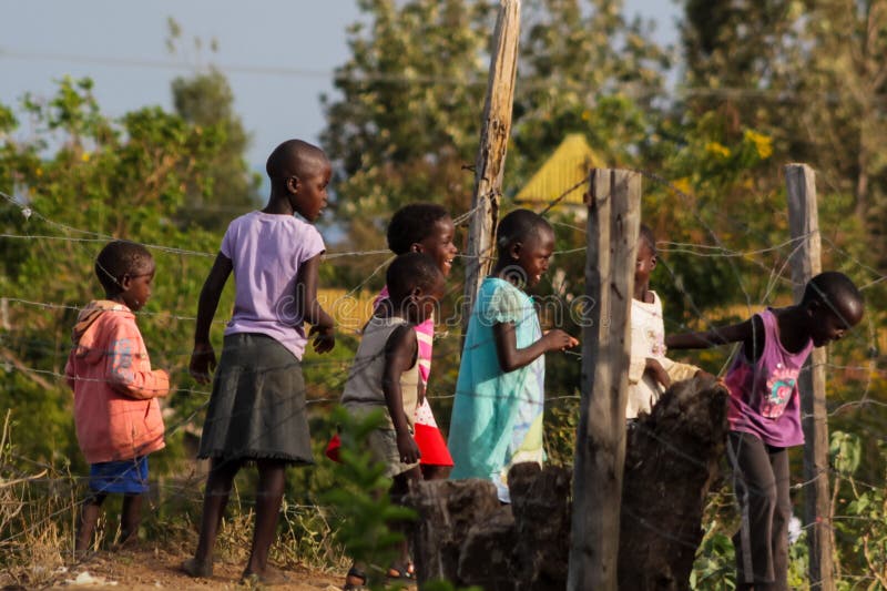 African poor children on the street near fence