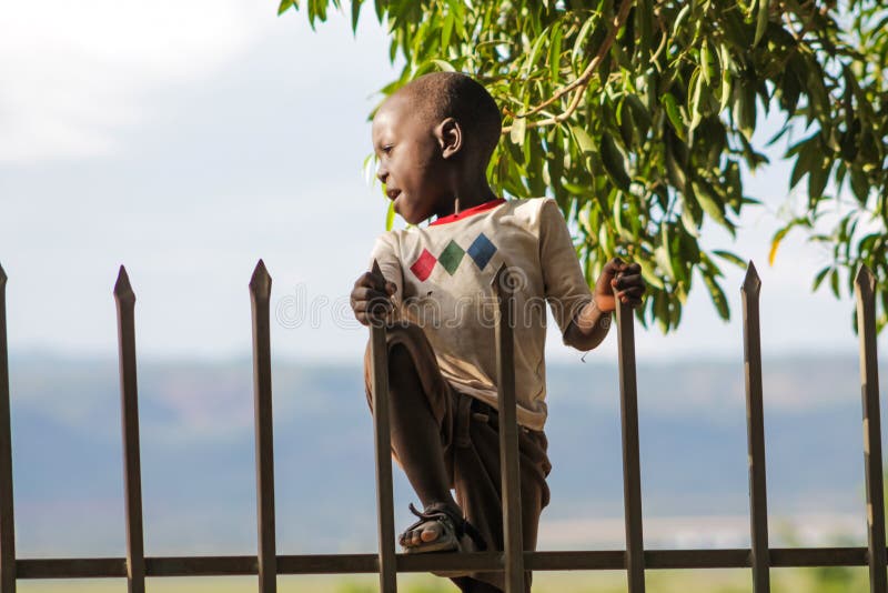 African poor children on the street near fence