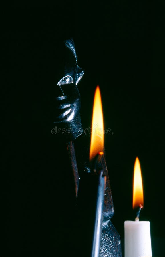 African statue with candle stock image. Image of candle 136578041