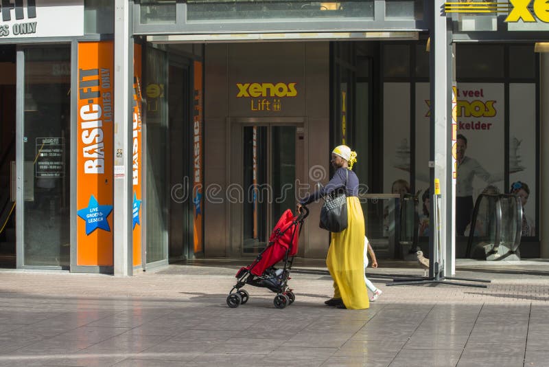 An African woman carrying a baby carriage stock photo An African woman carrying a baby carriage stock photo