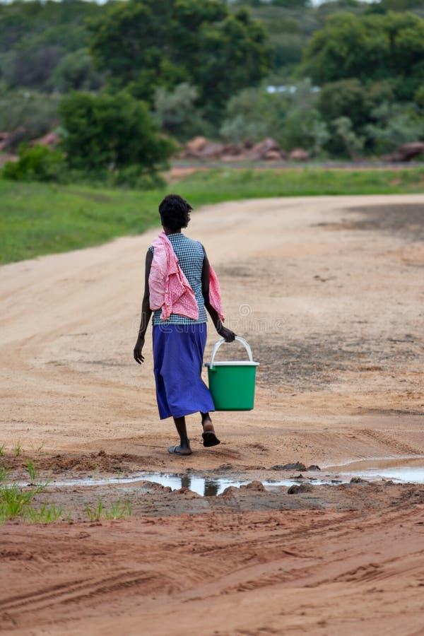 African woman carrying water royalty free stock photography