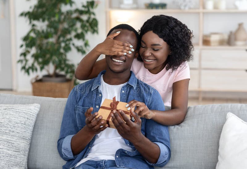 African Woman Giving Gift Box To Her Man Stock Photo - Image of gift ...