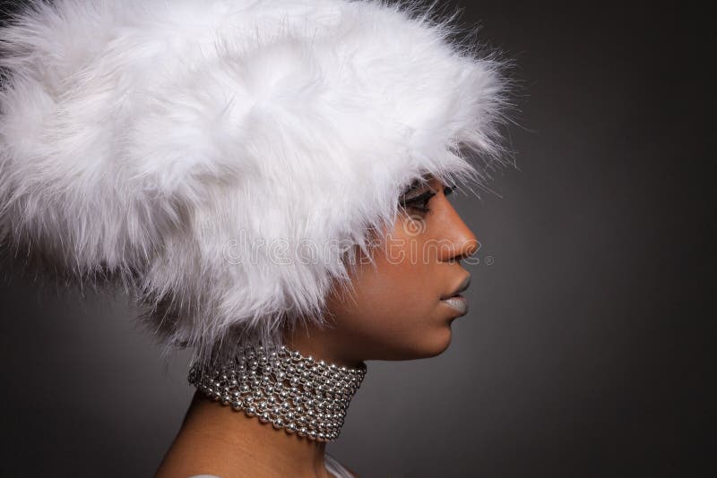 African woman in white hat and silver necklace