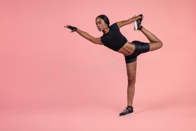 Free Photo  African woman doing yoga in studio. pink background.