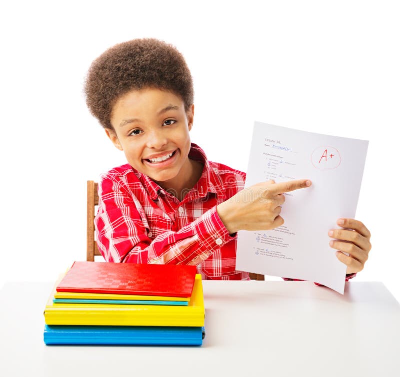 Happy smiling African American school boy, teenager point at A grade on the test, school and education concept. Isolated, over white background with copy space. Happy smiling African American school boy, teenager point at A grade on the test, school and education concept. Isolated, over white background with copy space