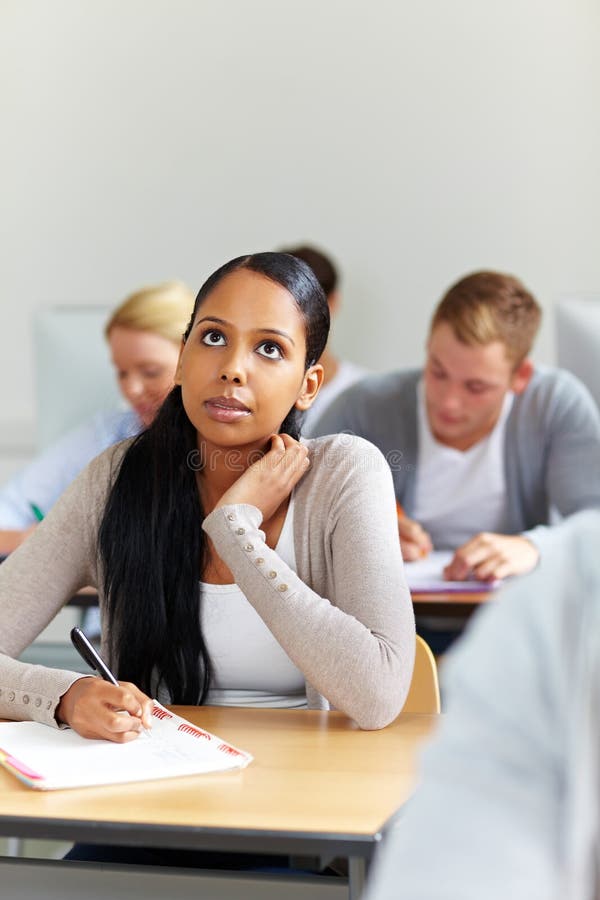 Female african student learning in university class. Female african student learning in university class