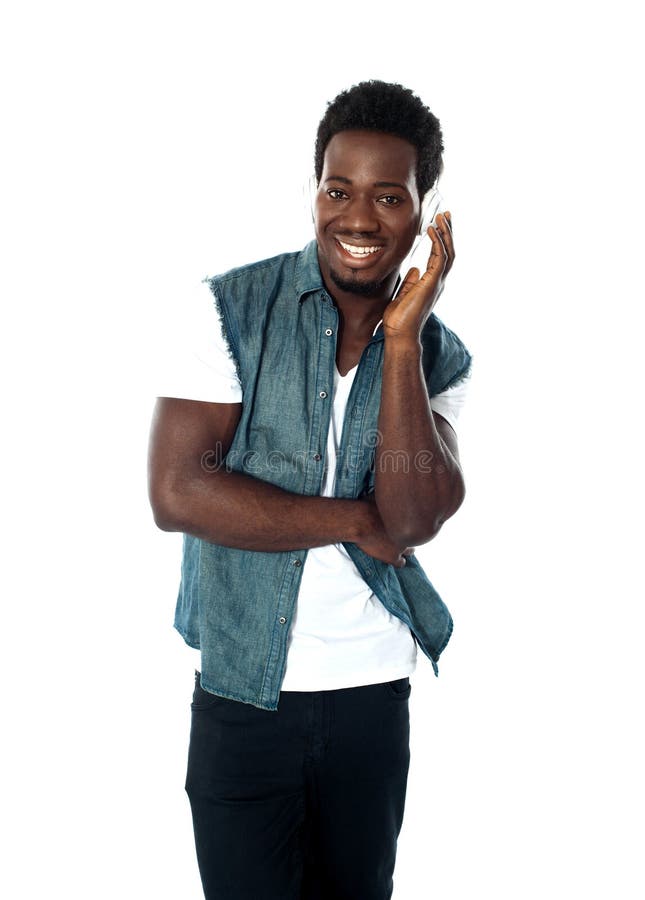 African teen boy enjoying music holding headphones. African teen boy enjoying music holding headphones