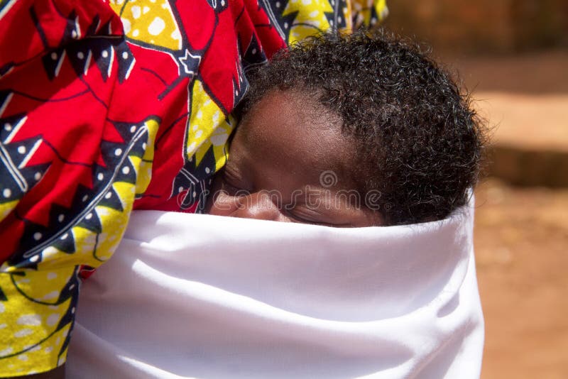 RUHENGERI, RWANDA-NOVEMBER 3, 2013: portrait of unidentified baby is transported back to the mother in Ruhengeri, Rwanda, November 3, 2013. RUHENGERI, RWANDA-NOVEMBER 3, 2013: portrait of unidentified baby is transported back to the mother in Ruhengeri, Rwanda, November 3, 2013