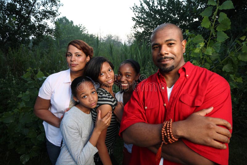 African American family together outdoors. African American family together outdoors