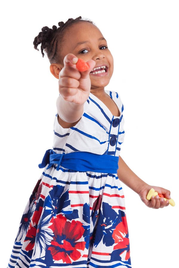 Portrait of a cute little african american girl eating candy, isolated on white background. Portrait of a cute little african american girl eating candy, isolated on white background