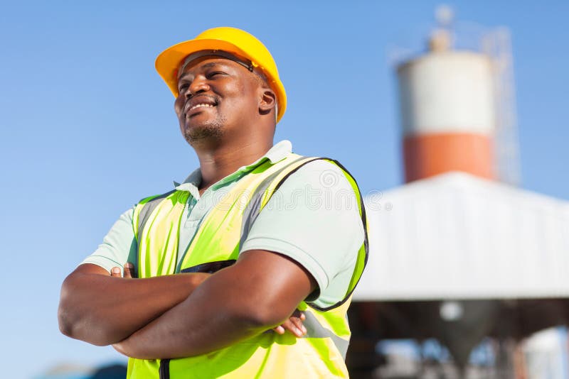 Happy african male constructor with arms folded. Happy african male constructor with arms folded