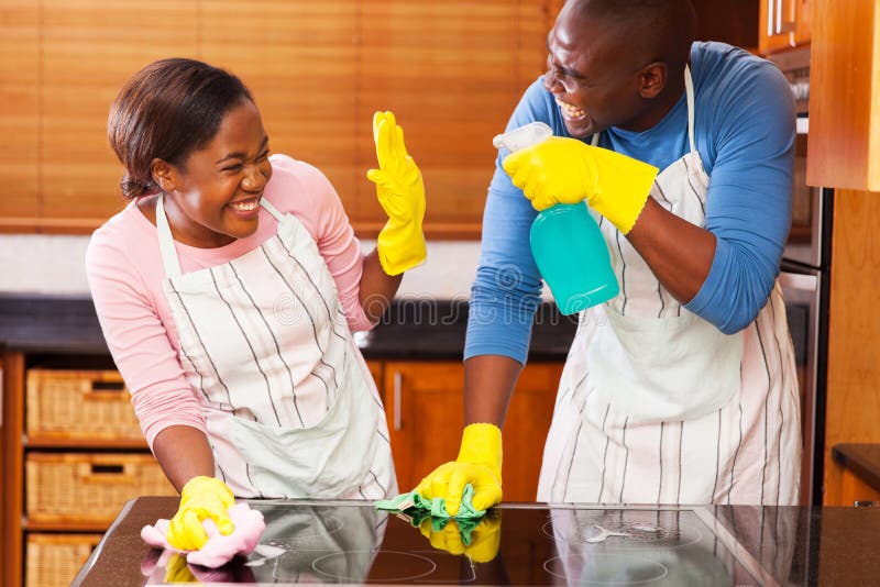 Young african couple having fun while doing household chores. Young african couple having fun while doing household chores