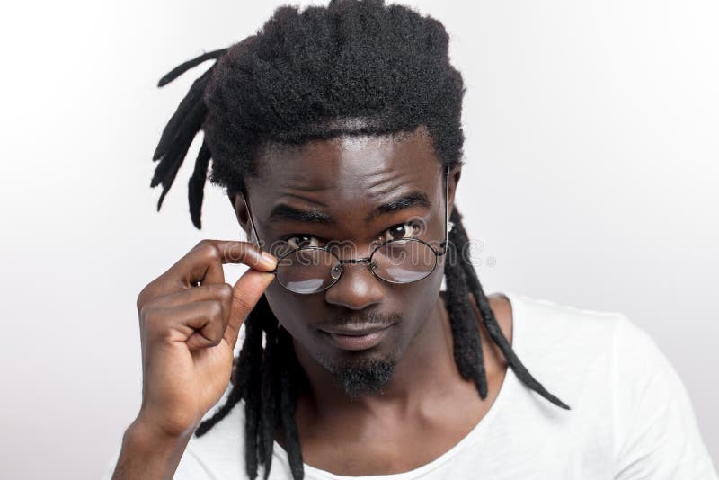 Afro American Man With Dreadlocks And Glasses Is Looking At Camera