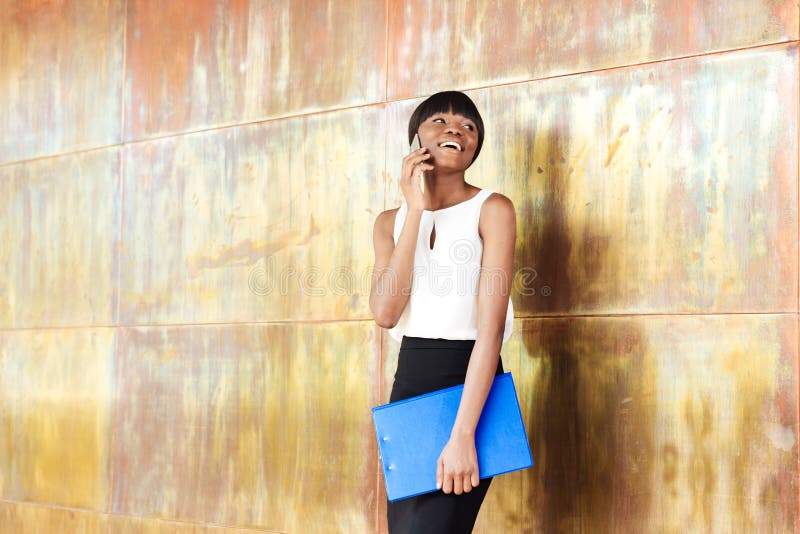 Afro american woman talking on the phone in office royalty free stock photos