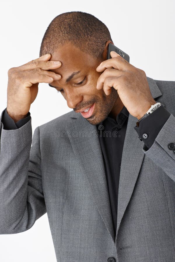 Afro businessman talking on phone