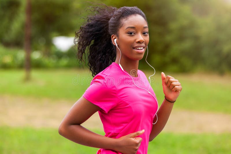 African american woman runner jogging outdoors - Fitness, people and healthy lifestyle. African american woman runner jogging outdoors - Fitness, people and healthy lifestyle