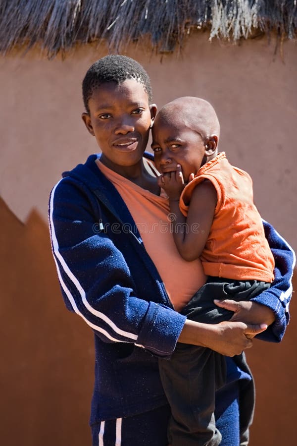 Portrait of an African child, in the harsh sun of Kalahari desert with tears in his eyes. Africa, Botswana. Portrait of an African child, in the harsh sun of Kalahari desert with tears in his eyes. Africa, Botswana.