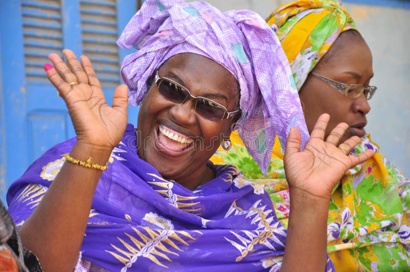 Black african women laughing, colorfully dressed in traditional outfit. Senegal. Black african women laughing, colorfully dressed in traditional outfit. Senegal