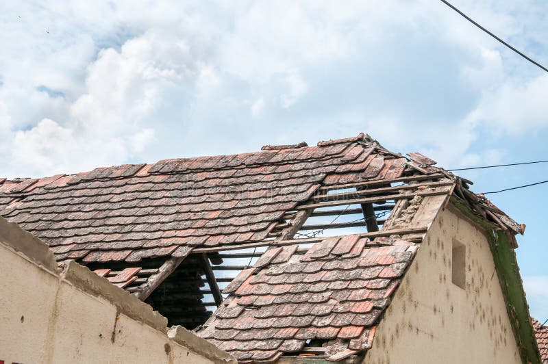 Aftermath damaged and collapsed roof on ruined house with wooden construction frame and brick wall stock photos Aftermath damaged and collapsed roof on ruined house with wooden construction frame and brick wall stock photos