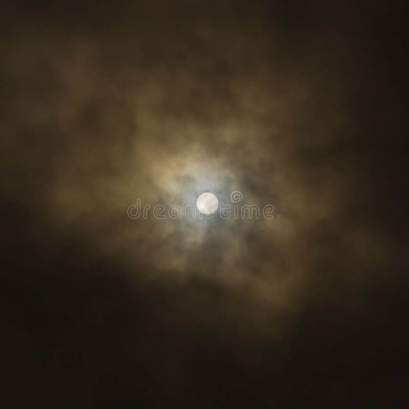 Afternoon Sun DisÑ Through Heavy Clouds royalty free stock images