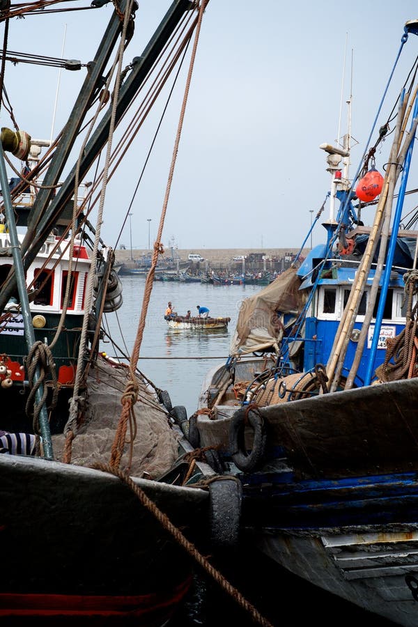 African fishing boats docked in a harbor next to the wholesale market stock photos African fishing boats docked in a harbor next to the wholesale market stock photos
