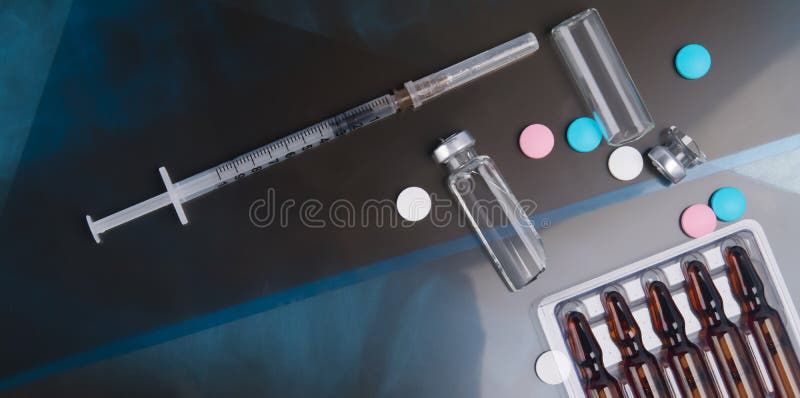 Against a dark background of medical images, fluorography, a syringe with drugs, a set of ampoules with drugs, pills and broken glass