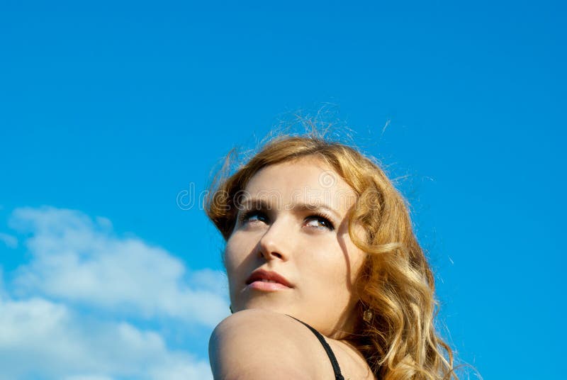 Against the sky-a beautiful red-haired girl