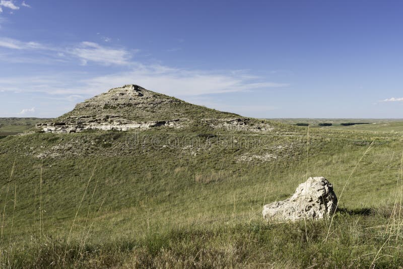 Agate Fossil Beds National Monument is located on the North Western Panhandle of Nebraska. University Hill with fossil sites are in the distance with a paved trail going to informational site. Agate Fossil Beds National Monument is located on the North Western Panhandle of Nebraska. University Hill with fossil sites are in the distance with a paved trail going to informational site.