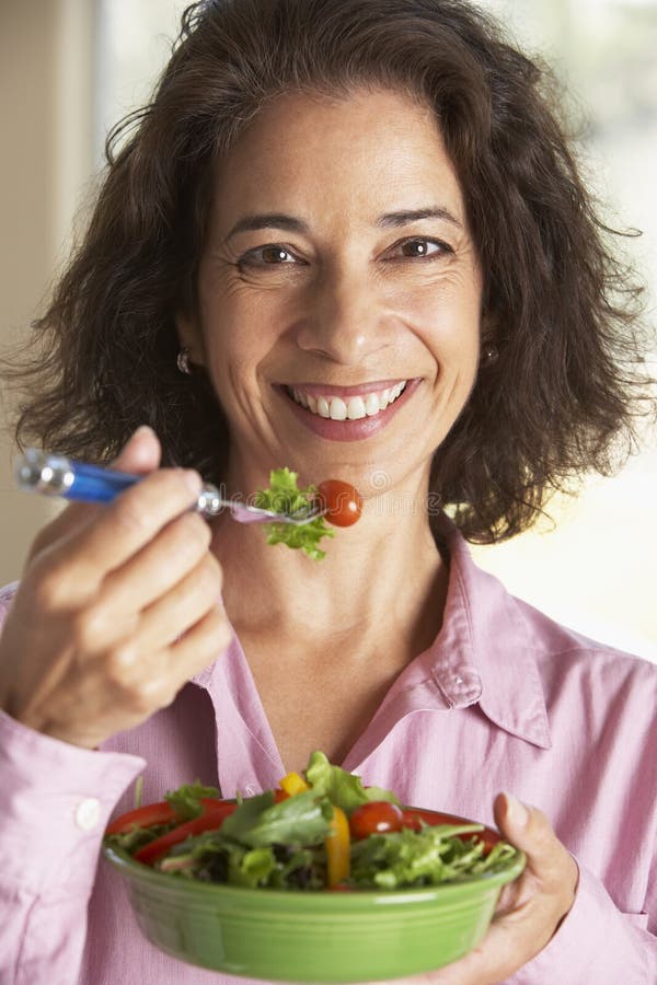 Middle Aged Woman Eating A Salad. Middle Aged Woman Eating A Salad.