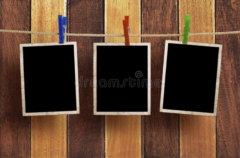 Aged photo frames on wood background stock photography