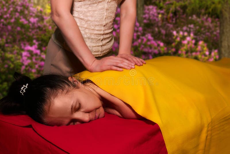 Aged Woman Receives A Back Massage From A Private Massage Therapist