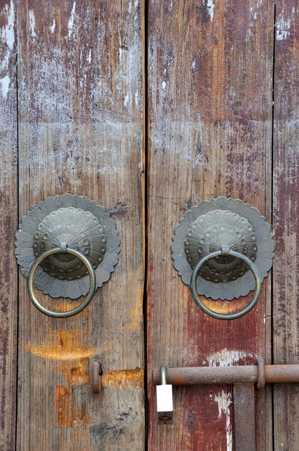 Aged wooden door with knocker and lock